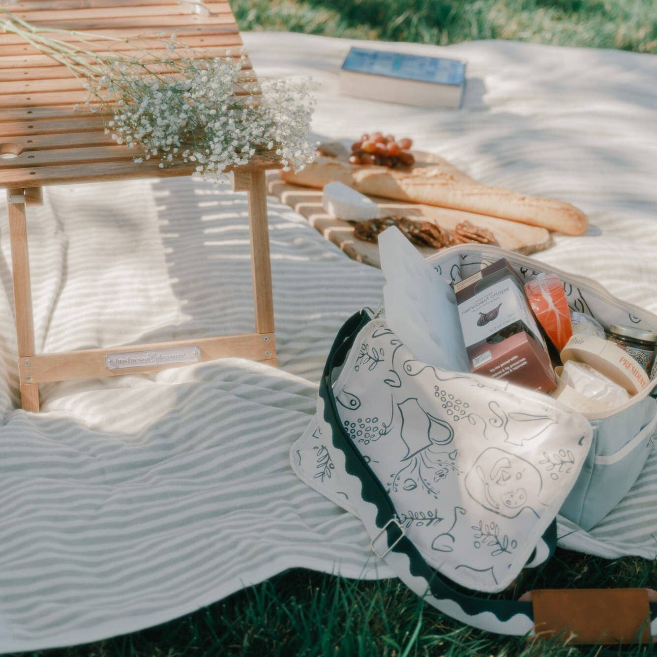 Picnic setting with riviera green cooler, sage blanket & folding table
