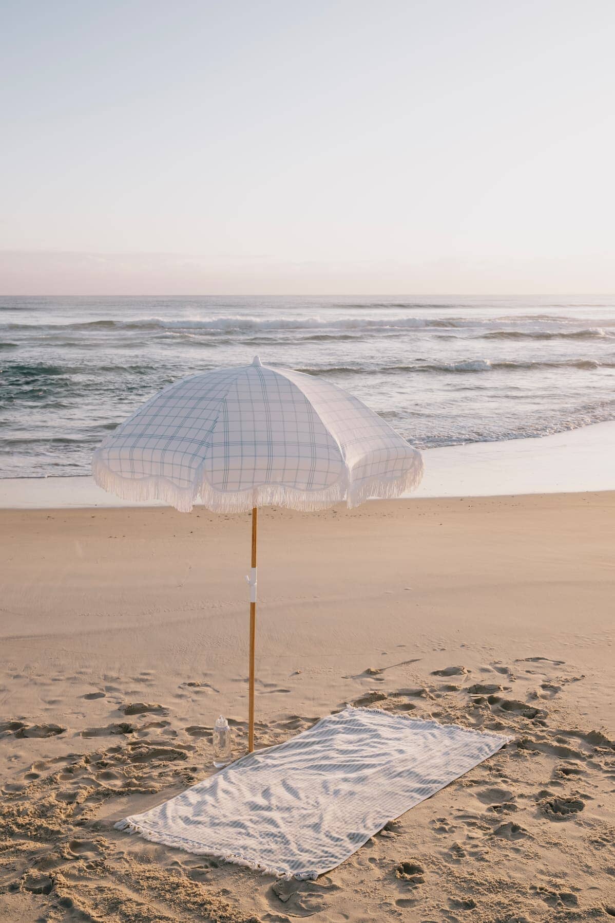 blue plaid holiday umbrella on the beach