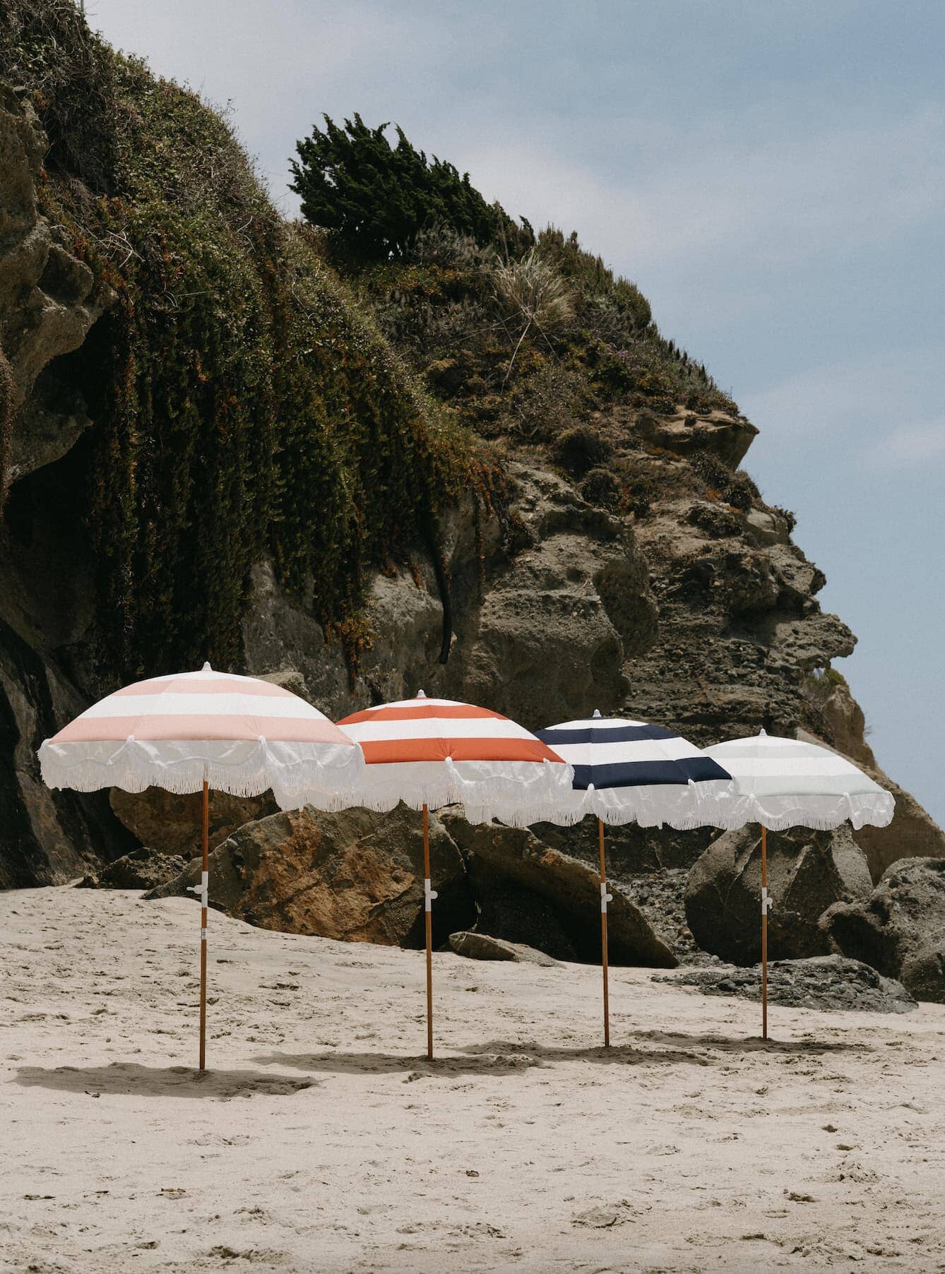 4 holiday beach umbrellas on the beach