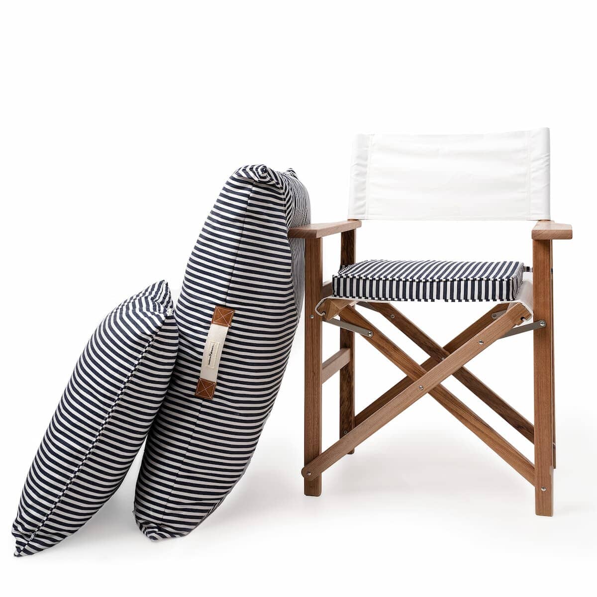 Studio image of floor cushion and euro cushion leaning against a directors chair