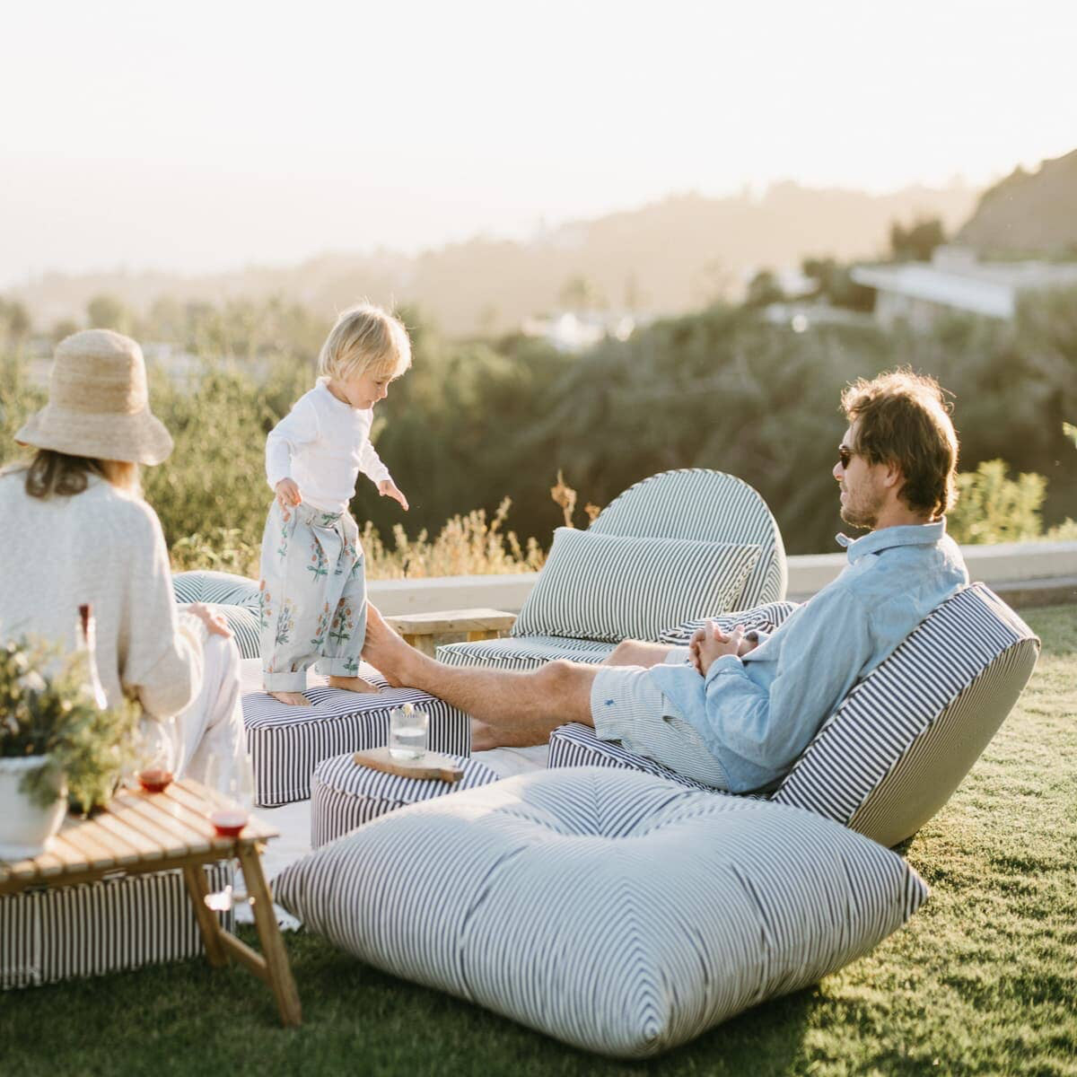 Family enjoying an outdoor picnic on the reclining lounger