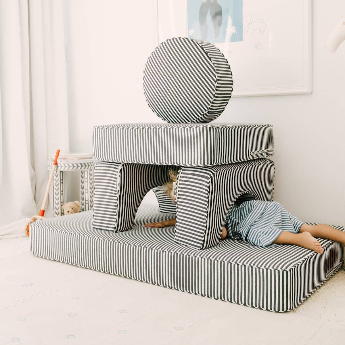 A child climbing through the stacked modular pillow stack