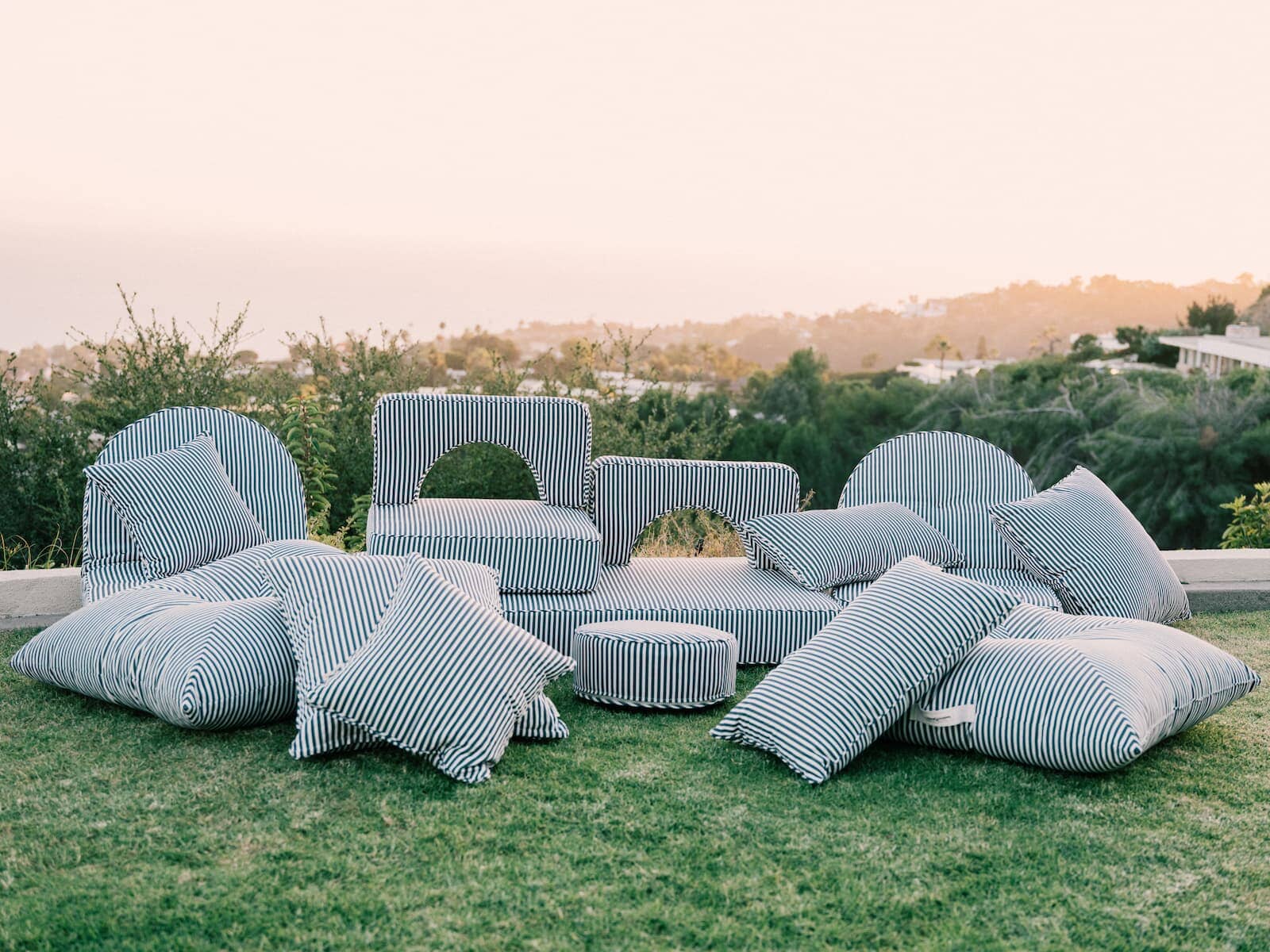 Outdoor image of the entire outdoor cushion collection on the grass