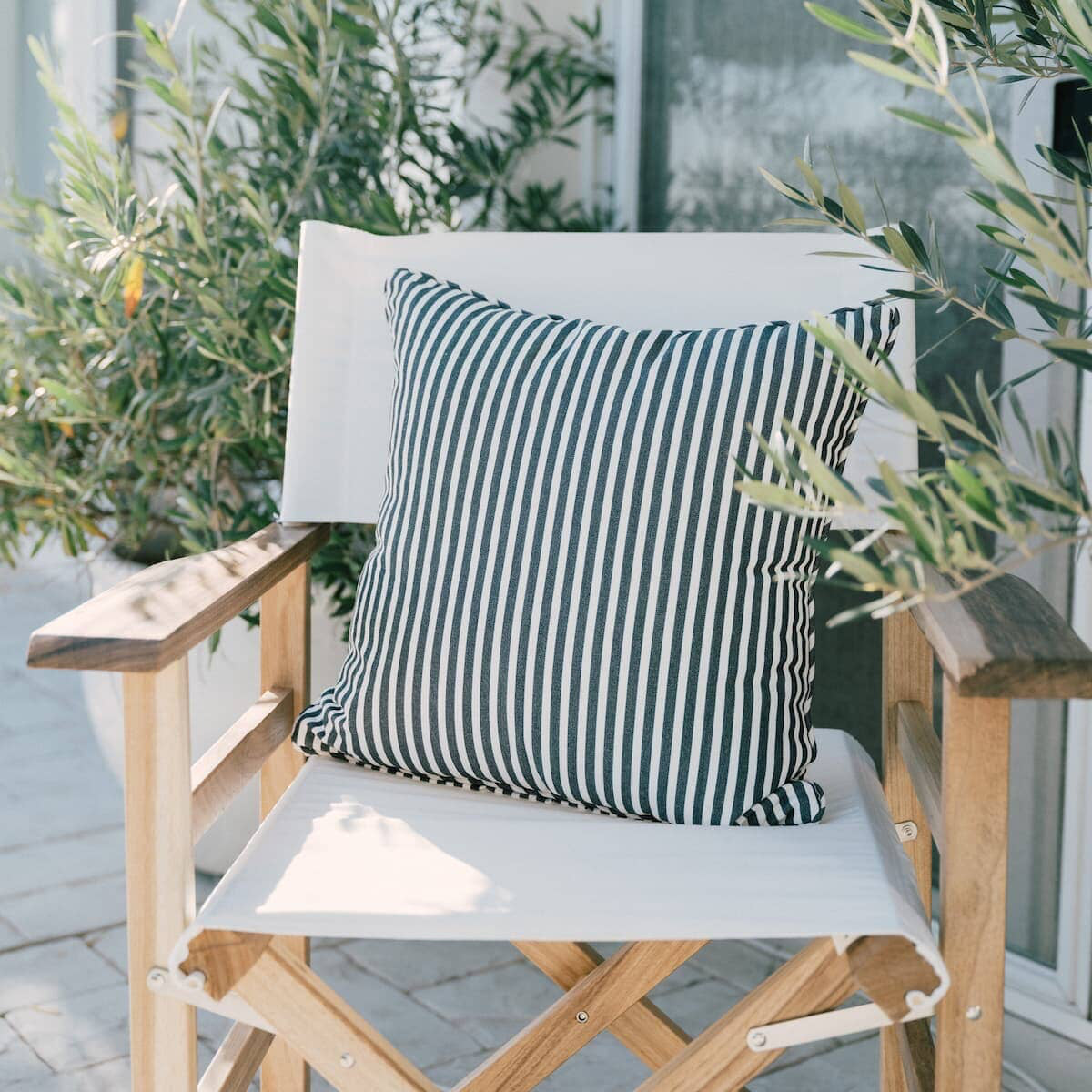 navy stripe small square throw pillow on a directors chair