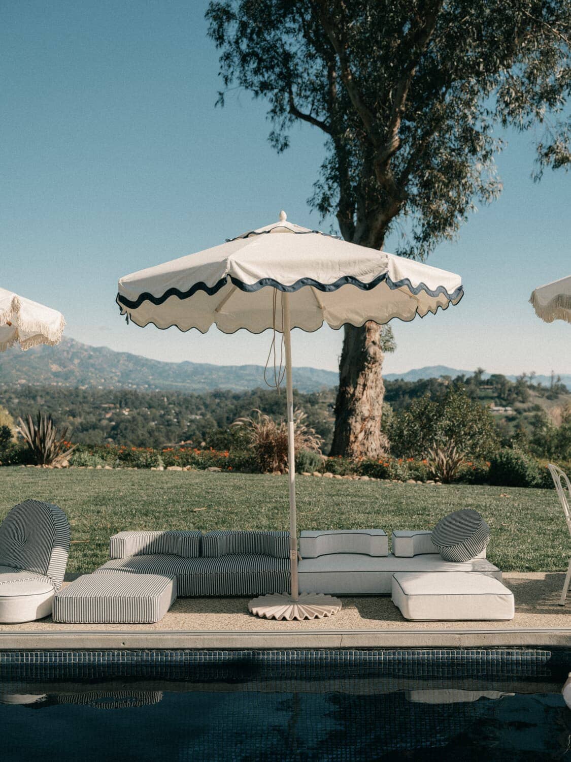 white market umbrella next to a pool