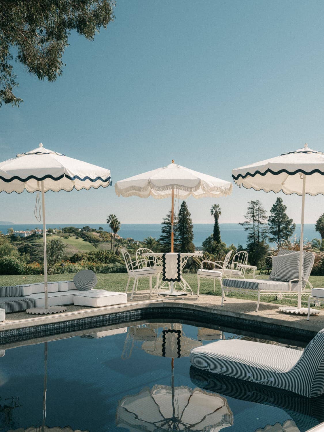 market umbrellas next to a luxury pool