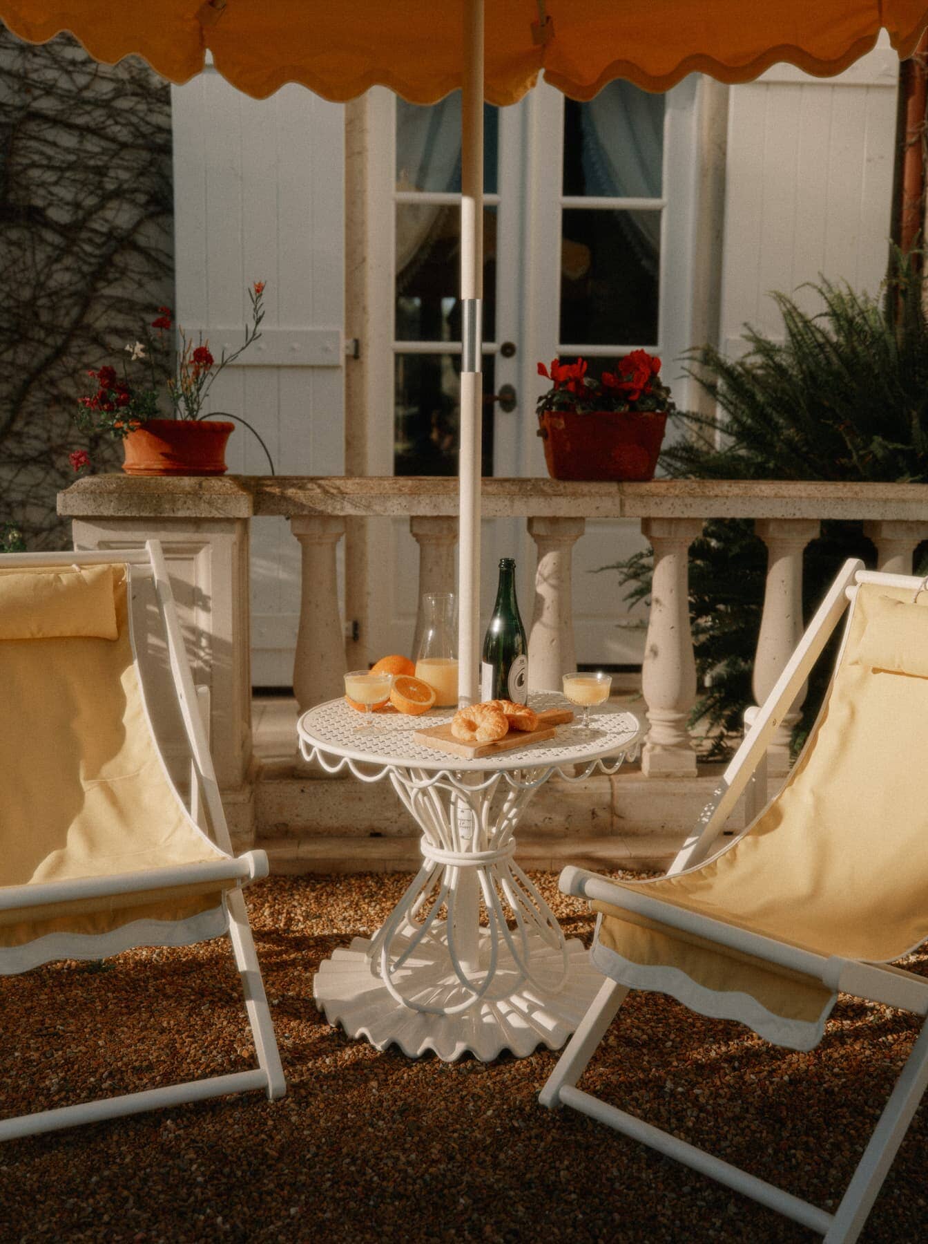 Patio setting with white table and riviera mimosa sling chairs