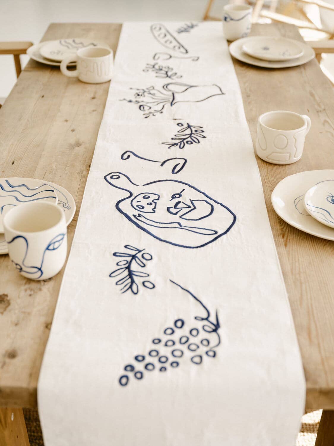 lauren's navy stripe table runner draping off the end of a table