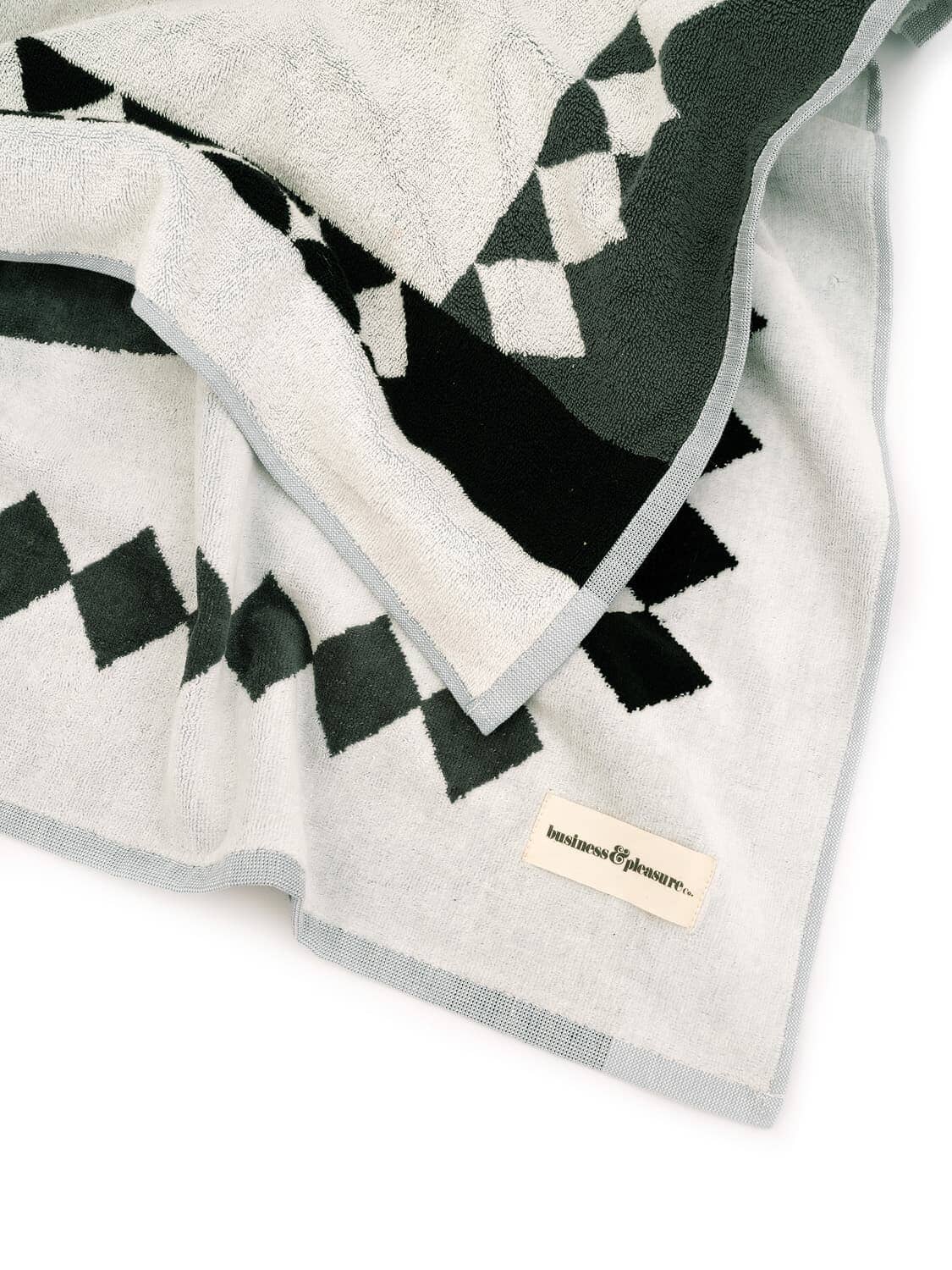 studio image of corner of diamond green beach towel