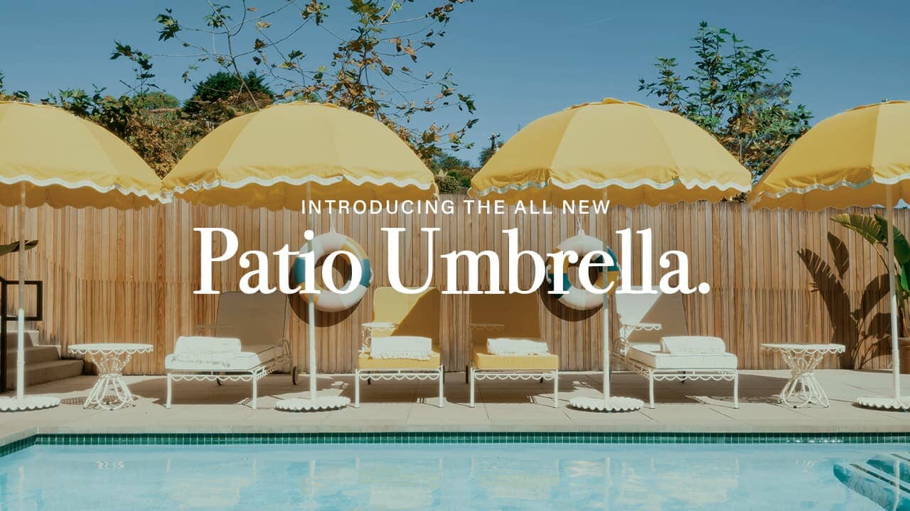 Yellow Patio Umbrellas featured by the poolside with sun loungers
