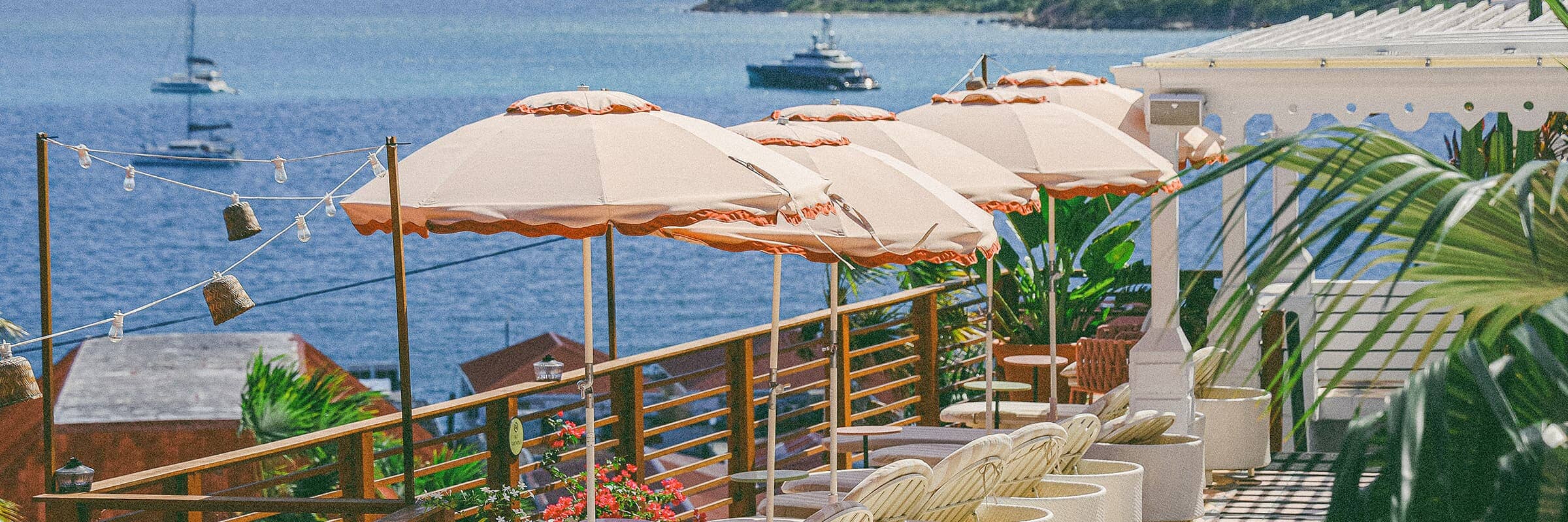 Pink Club Umbrellas in a resort setting overlooking the ocean
