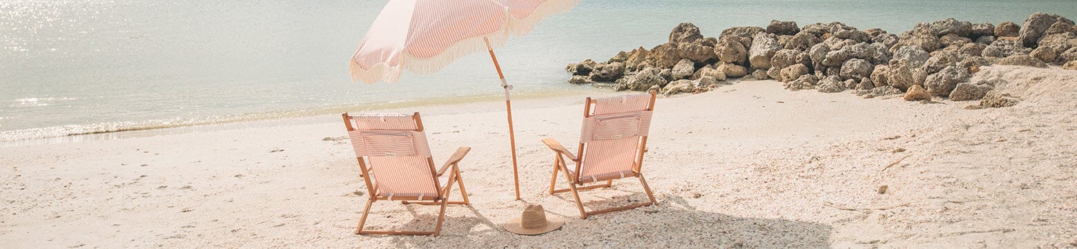 Lauren's Pink Stripe umbrella and Tommy Chairs on a beach
