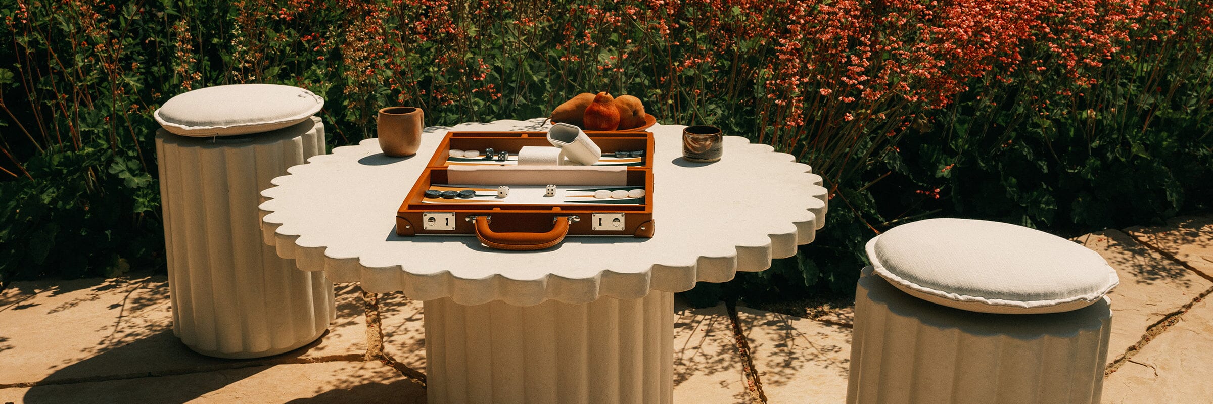 a garden party with multiple tables and umbrellas in a backyard