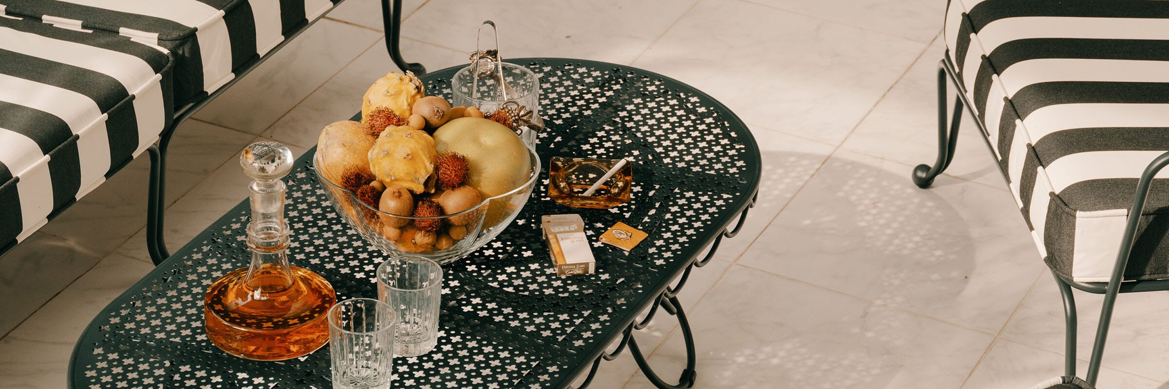 a garden party with multiple tables and umbrellas in a backyard