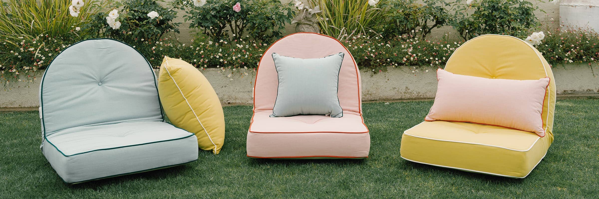 Brightly colored outdoor pillows on a lawn