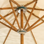 Close-up of a wooden patio umbrella with a beige canopy