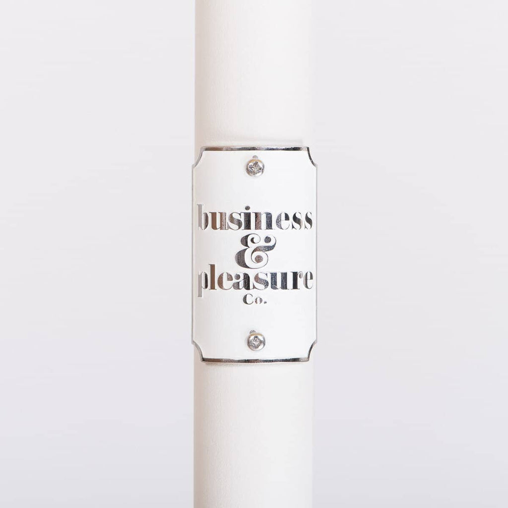 white umbrella pole with badge and logo