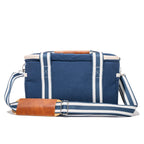 Blue and white striped bag with brown leather accents on a white background