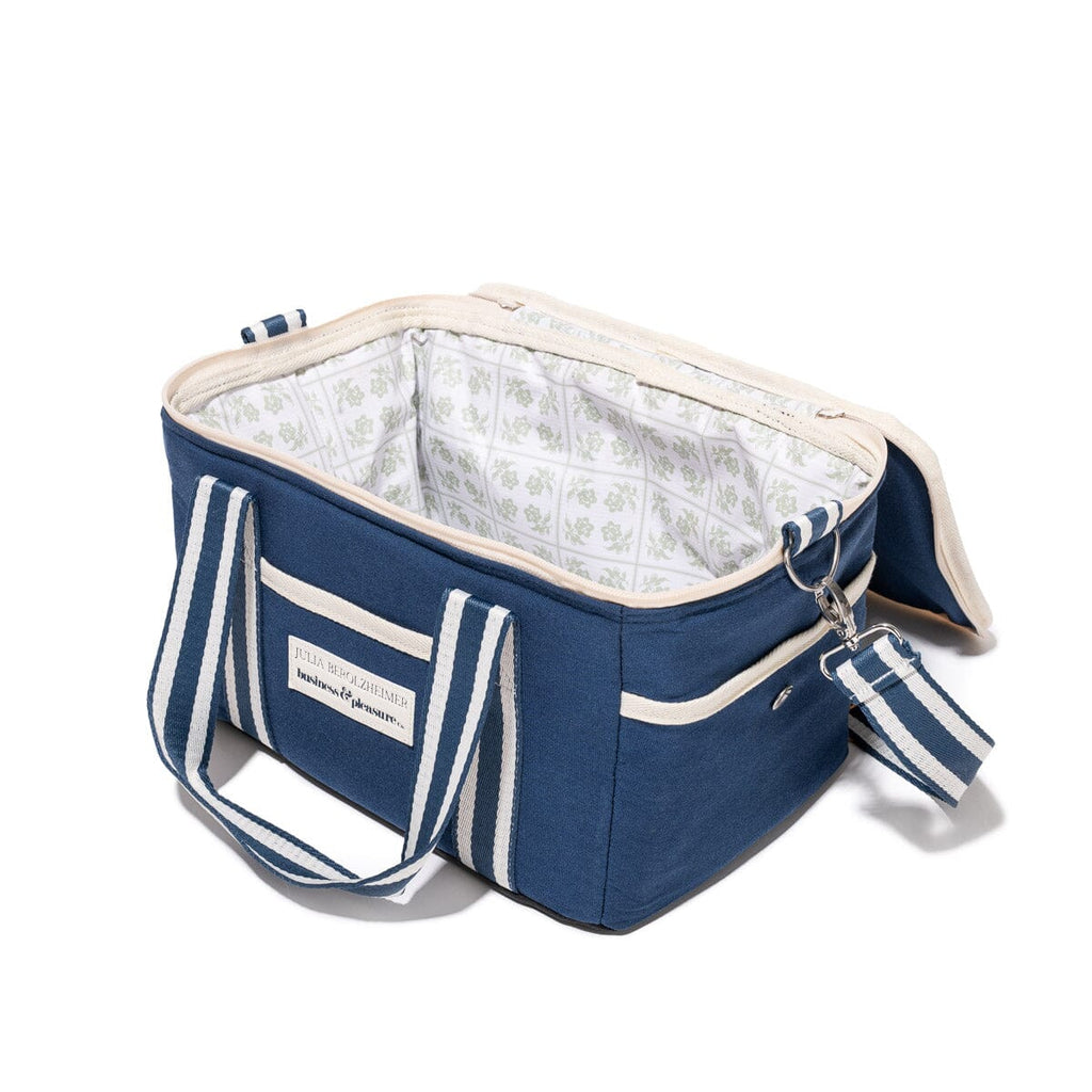 Blue cooler bag with white interior and matching tag on a white background