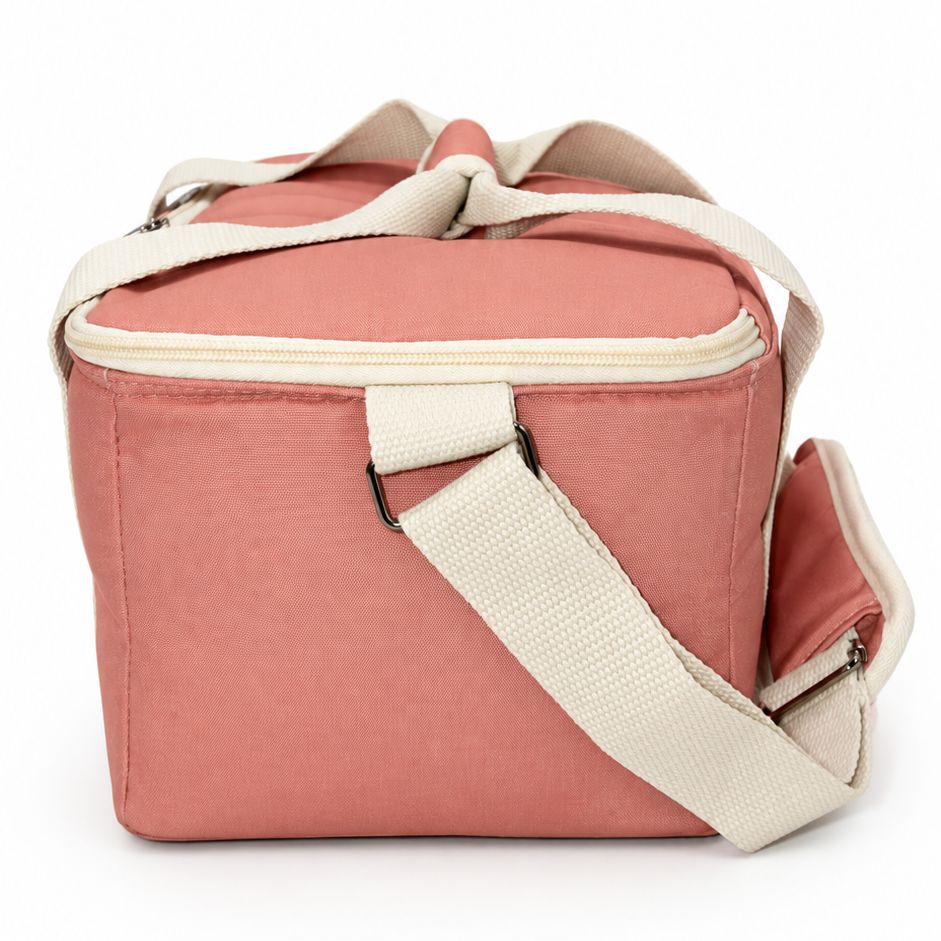 A dusty pink soft-sided cooler bag with cream-colored straps and trim, shown on a clean white background.