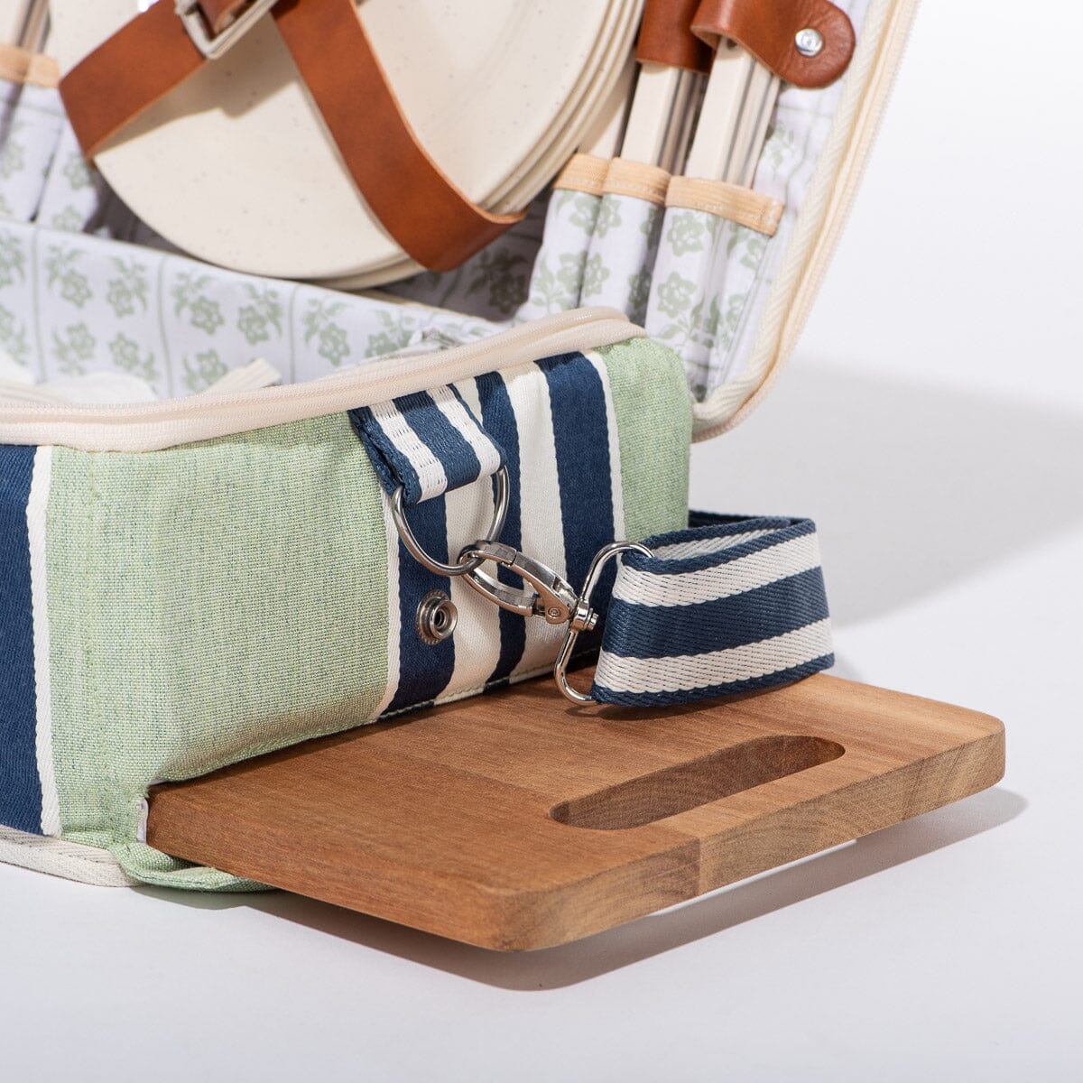 Close-up of a wooden tray with a striped fabric strap on a white background