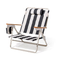 Black and white striped beach chair with wooden armrests on a white background