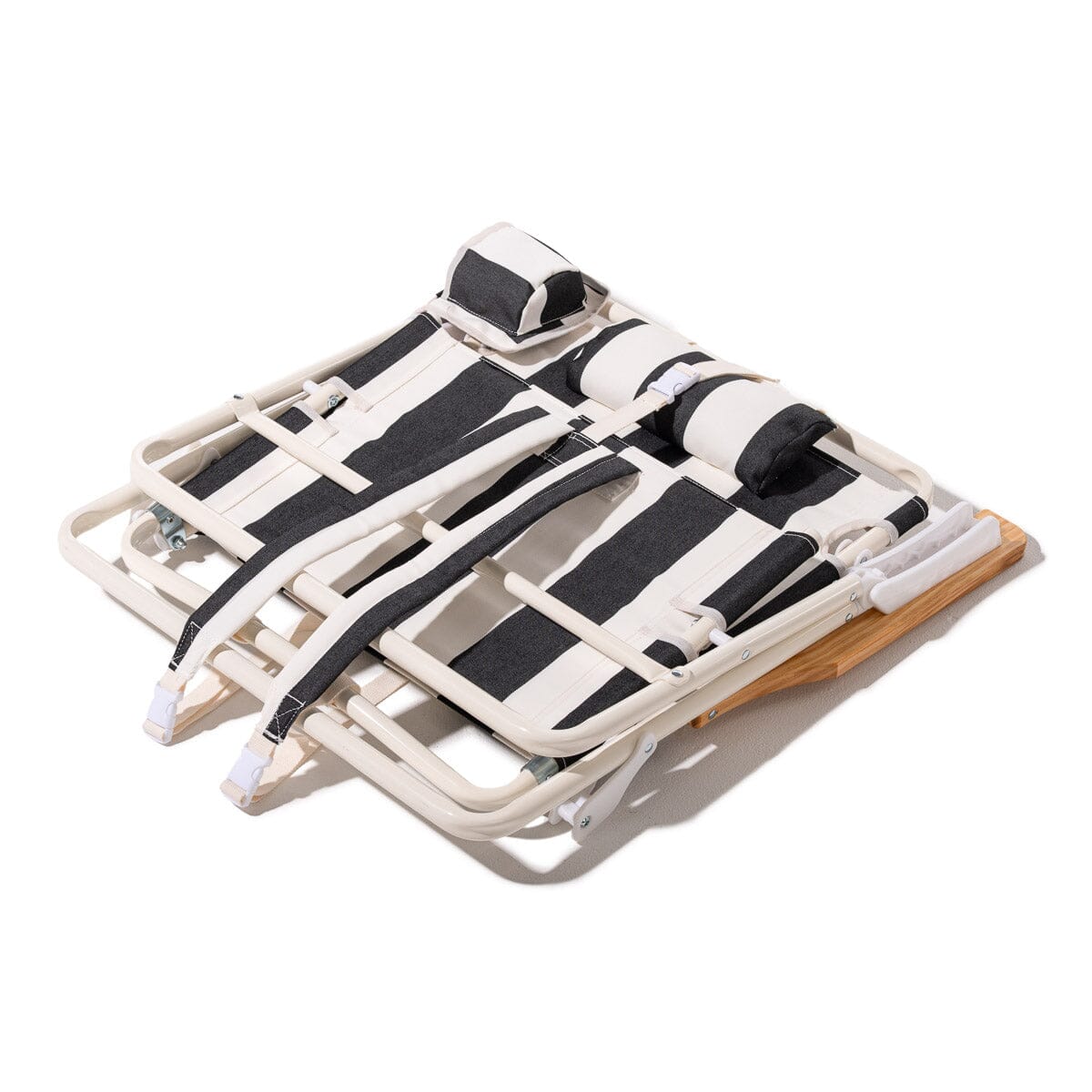Foldable beach chair with black straps on a white background
