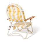 Yellow and white striped folding chair with wooden armrest on a white background