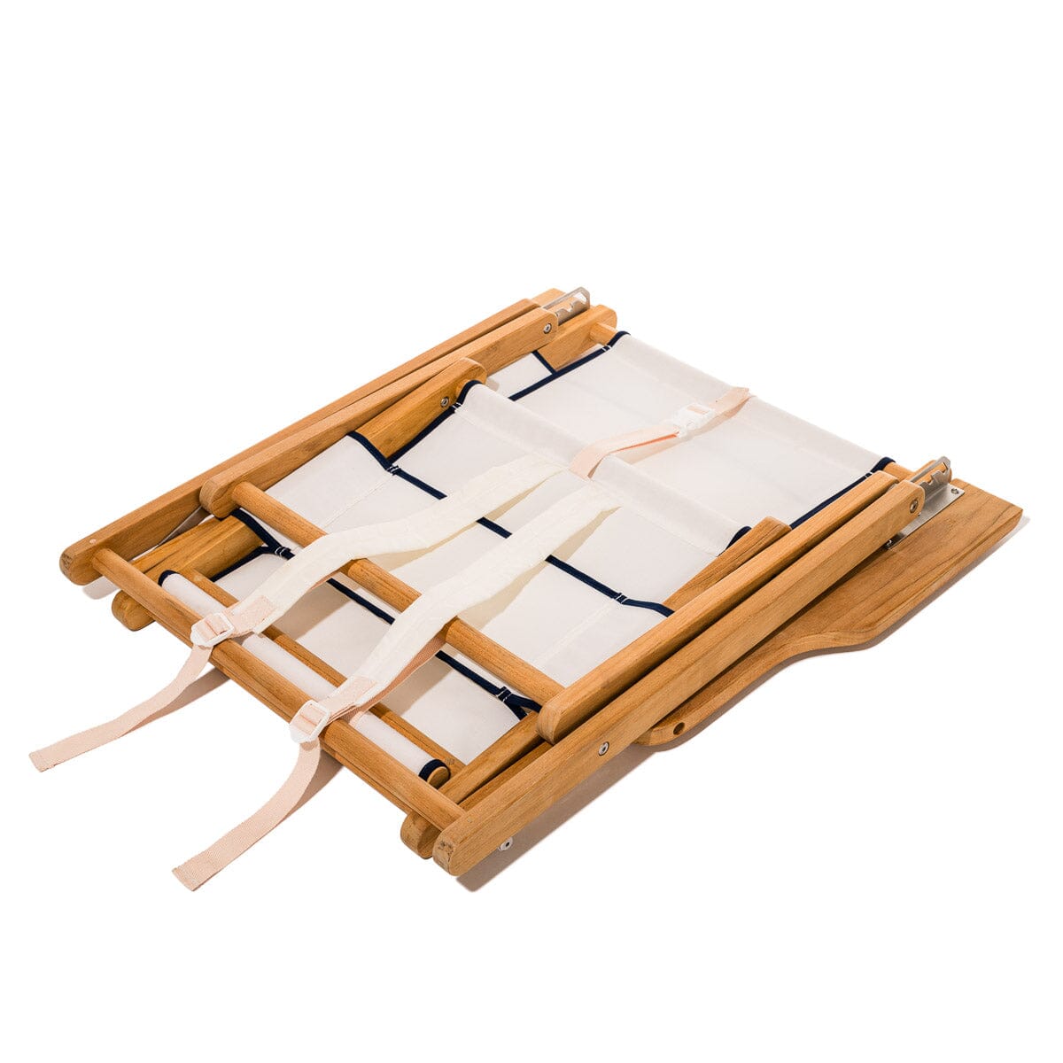 Wooden deck chair with white canvas seat and backrest with navy blue piping folded up