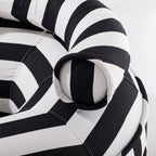 Close-up of a black and white striped pool float with striped pattern