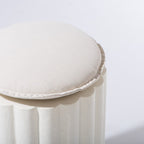 White cushioned stool on a light gray background