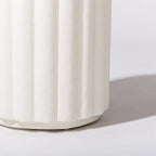 White ceramic Side Table close up view with ribbed texture on a light gray background