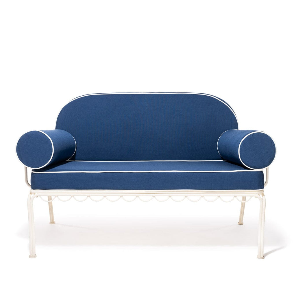 Blue sofa with cylindrical armrests on a white background
