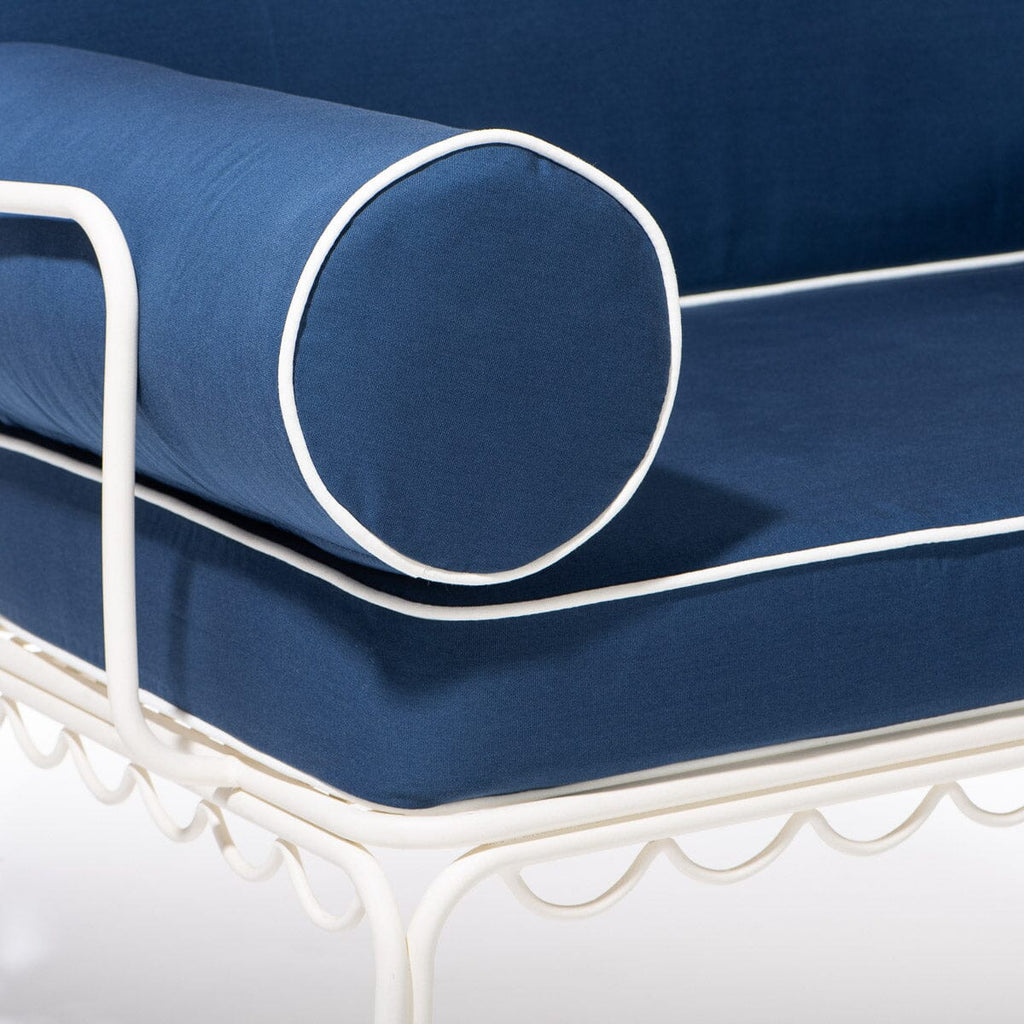 Blue cushion with white piping on a white metal frame