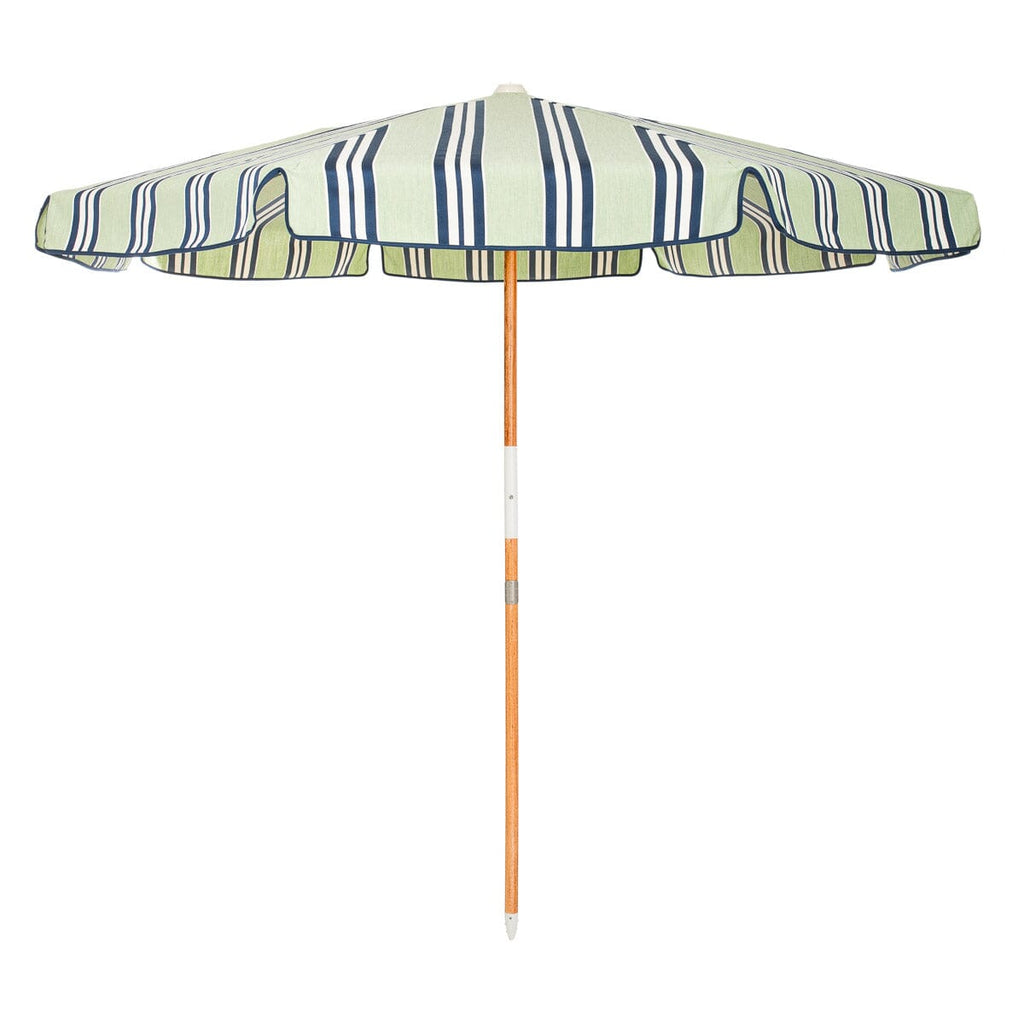 Striped beach umbrella with a wooden handle on a white background