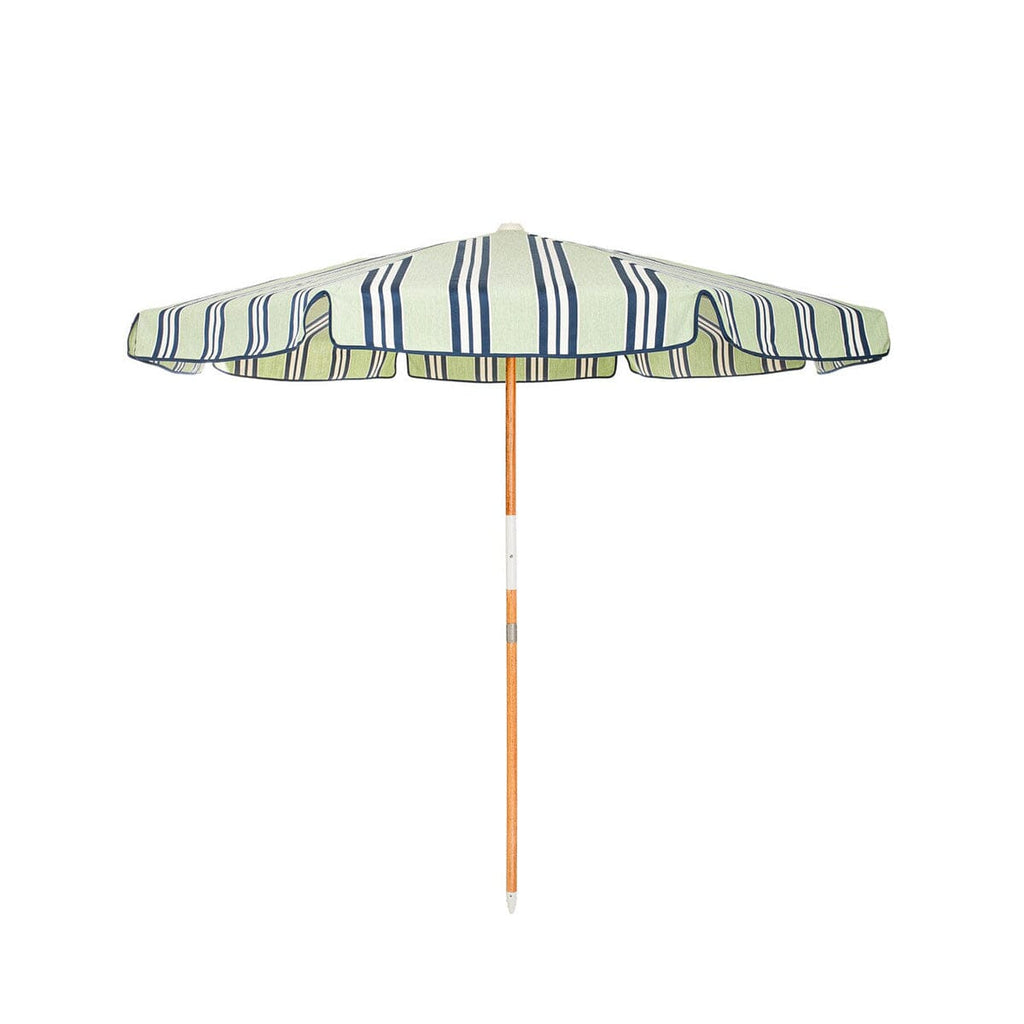 Striped beach umbrella with a wooden handle on a white background