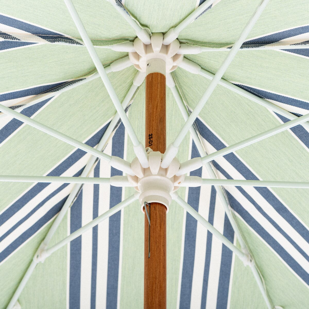 Close-up of a striped umbrella with a wooden handle