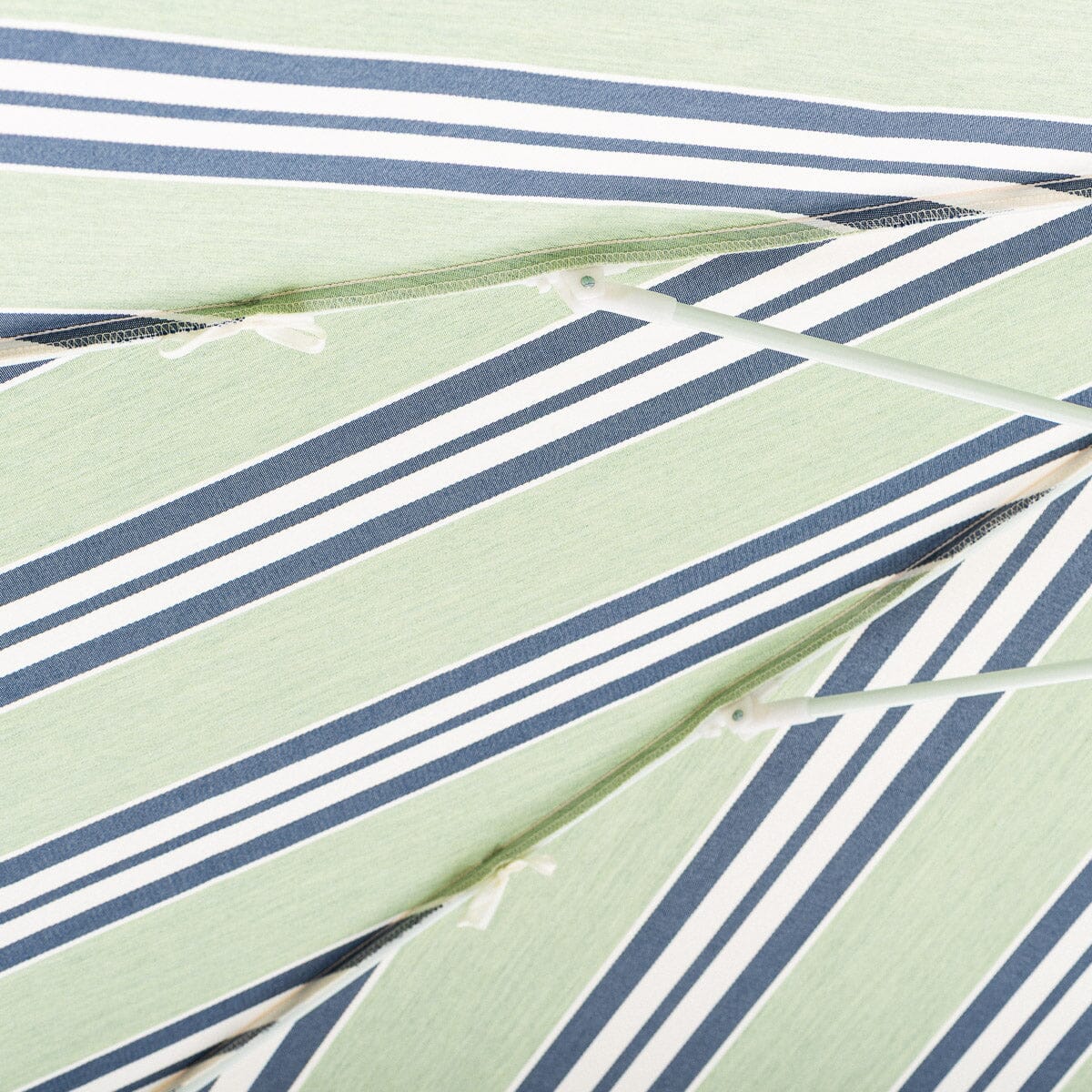 Close-up of a fabric with green, blue, and white striped pattern