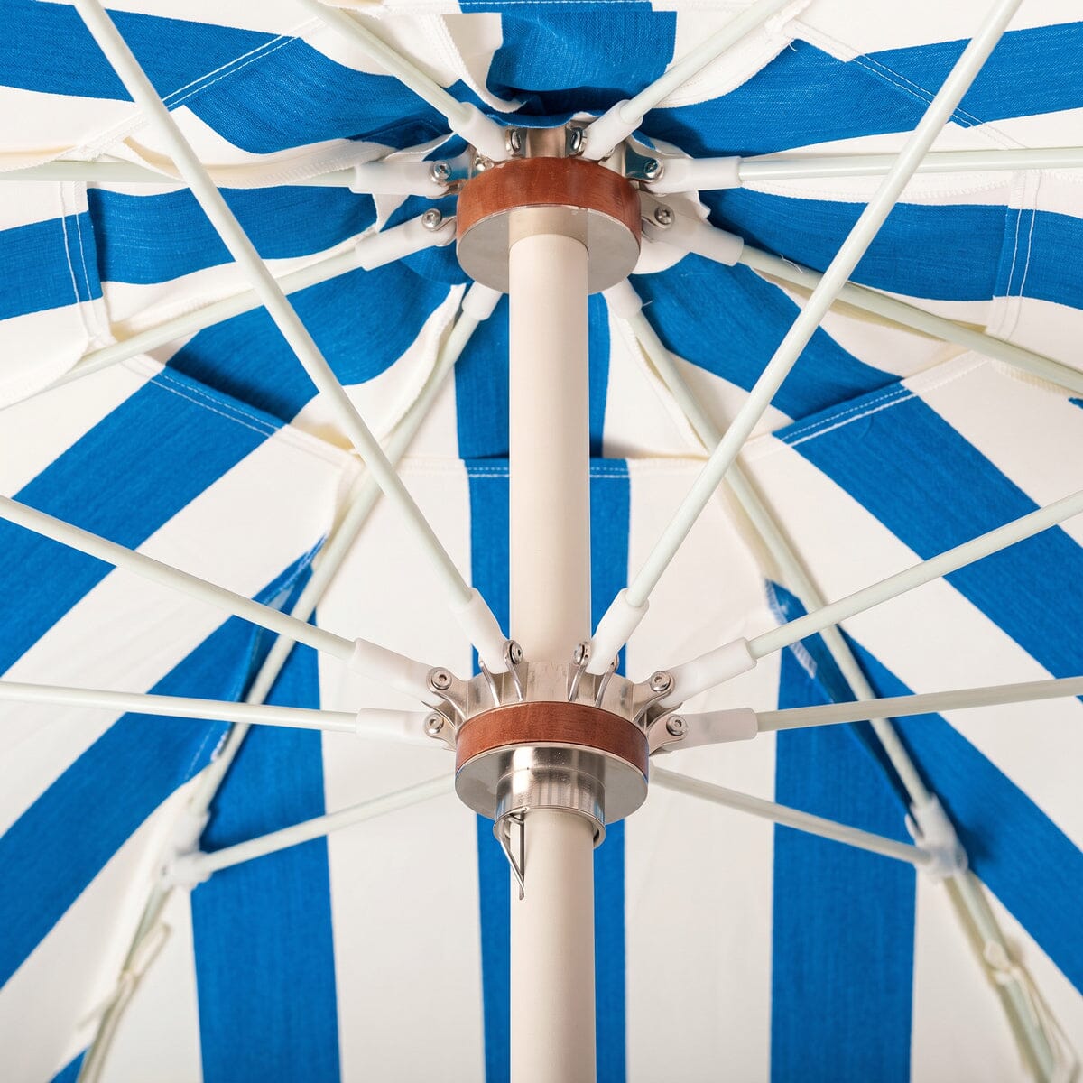 The Crew Mediterranean Blue Stripe Club Umbrella by Business & Pleasure Co with Antique White Pole and Metal Placement Mechanism