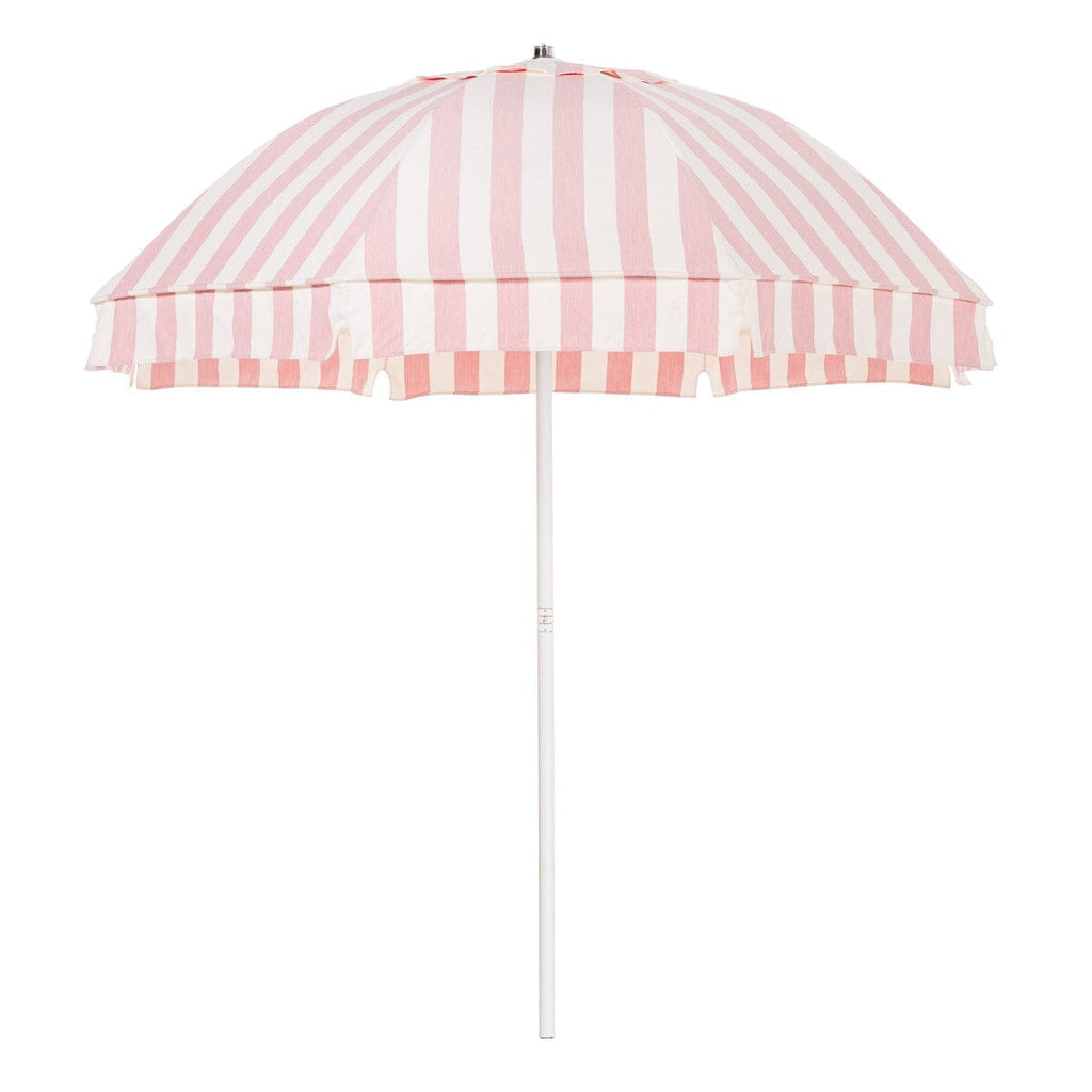 Pink and white striped beach umbrella on a white background