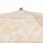 Beige & white floral patio umbrella on a white background