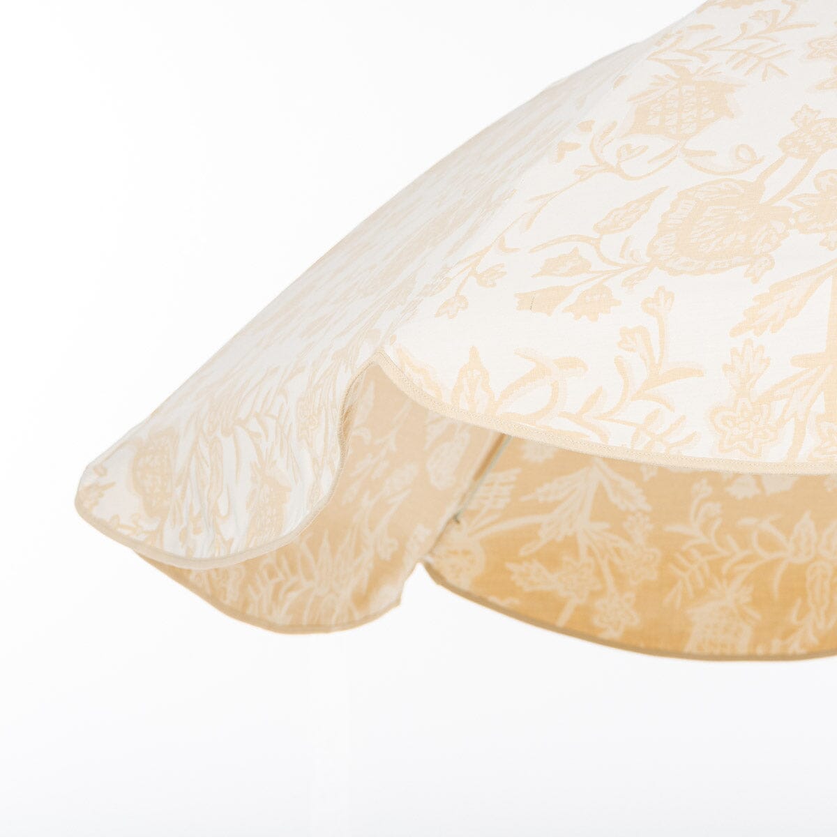 Beige & white floral patio umbrella with a scalloped edge on a white background