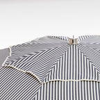 close up of chrome top cap on navy stripe patio umbrella