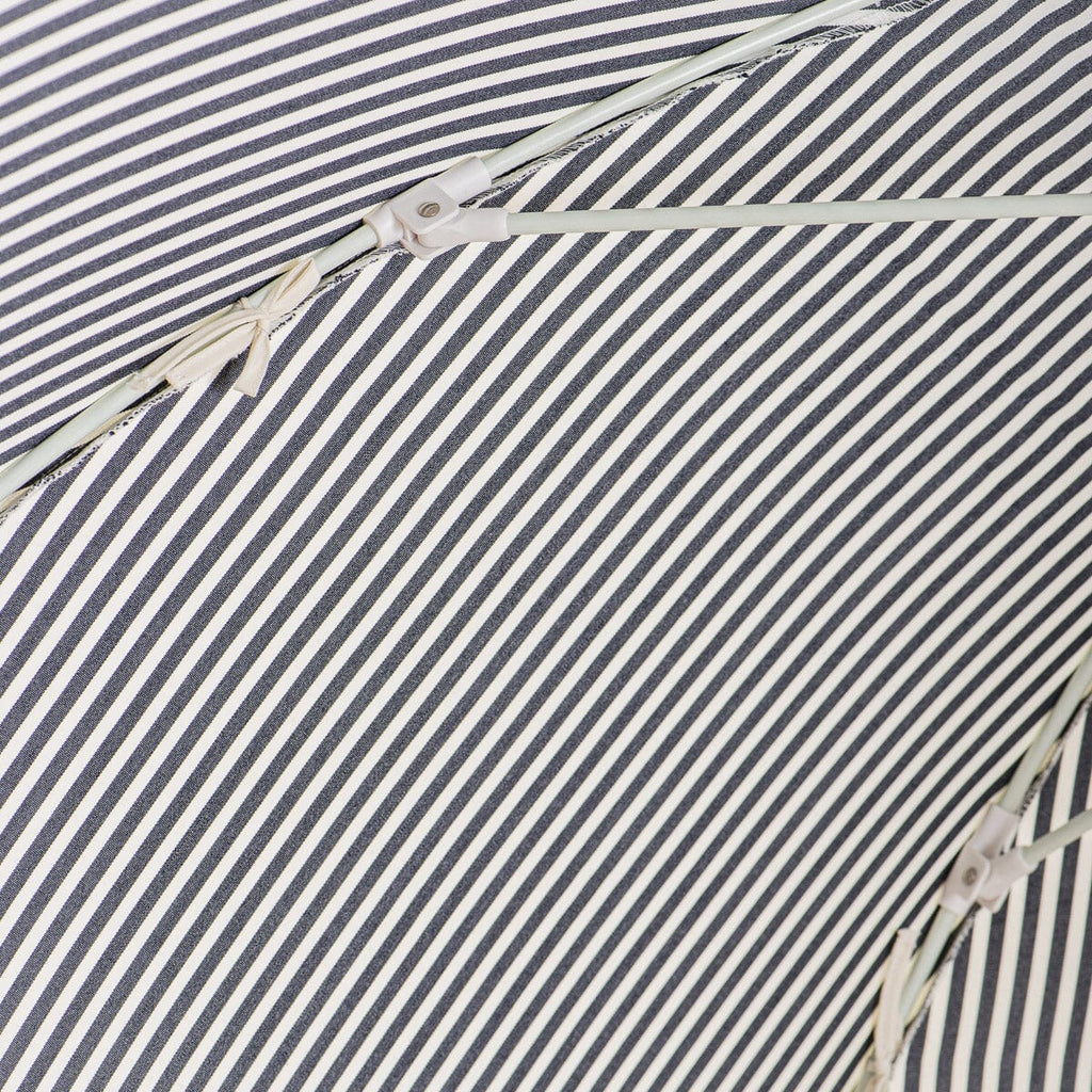 close up of canopy ties on navy stripe patio umbrella