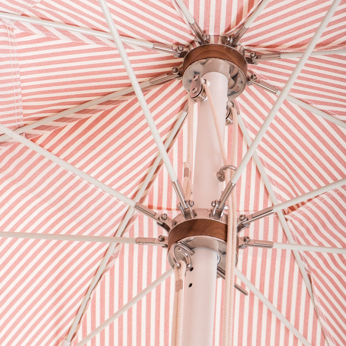 close up of hardware on pink stripe umbrella