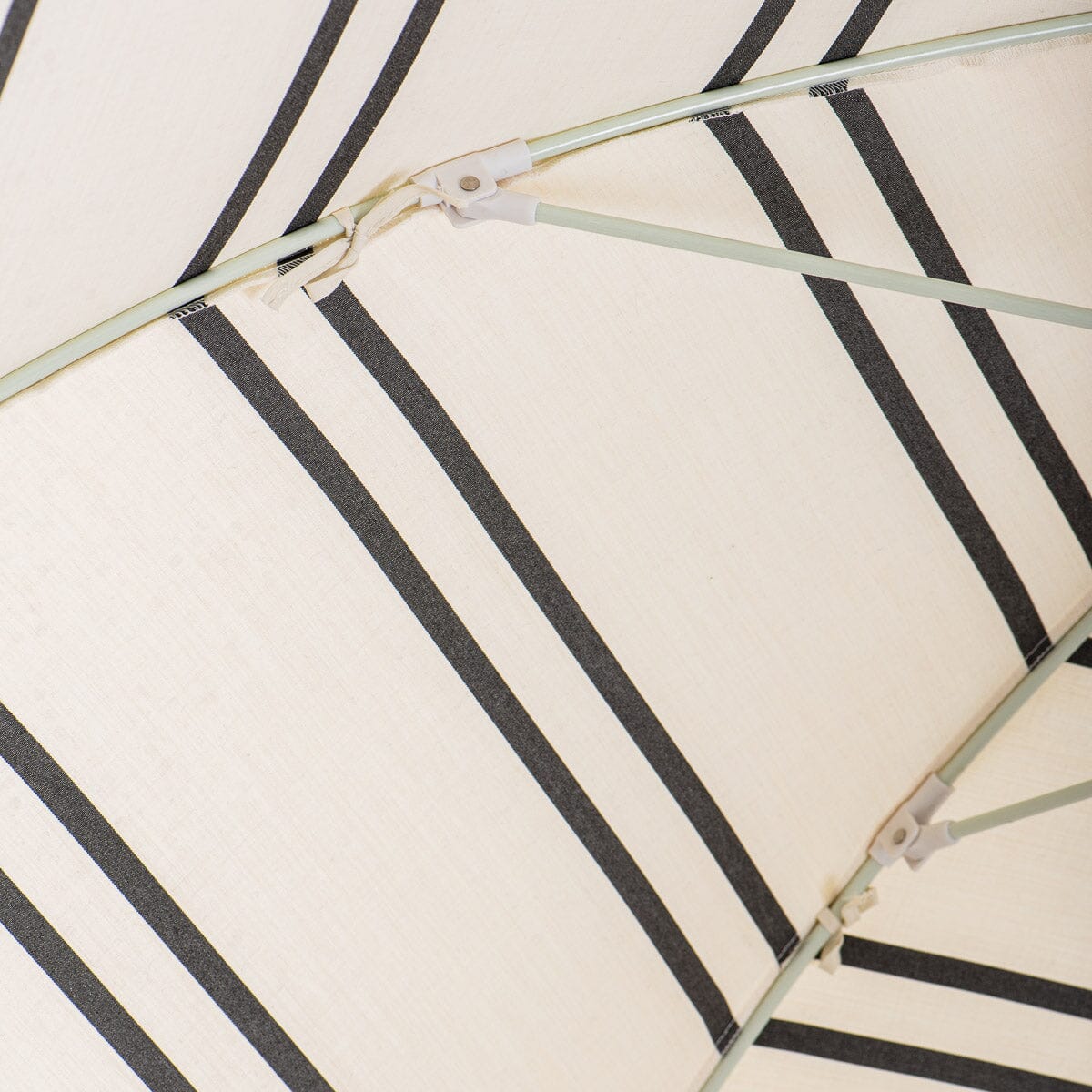 canopy ties detail on black and white stripe patio umbrella
