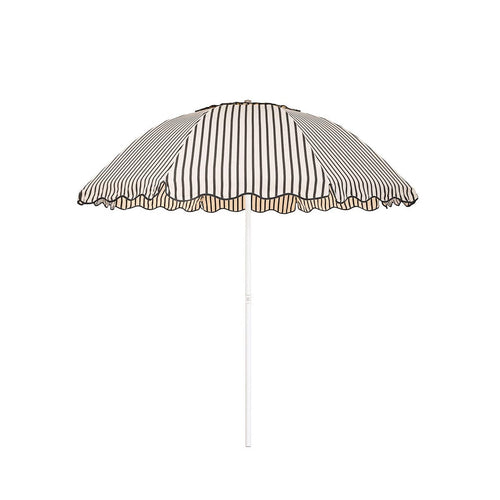 Business & Pleasure Co. Patio Umbrella in Monaco Black Stripe, featuring a dome-shaped cream canopy with fine black stripes, scalloped edges, black piping and a white center pole.