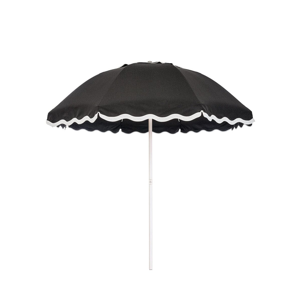 Business & Pleasure Co. Patio Umbrella in Rivie Black, featuring a black dome-shaped canopy with scalloped edges, contrasting white wave trim and a white center pole.