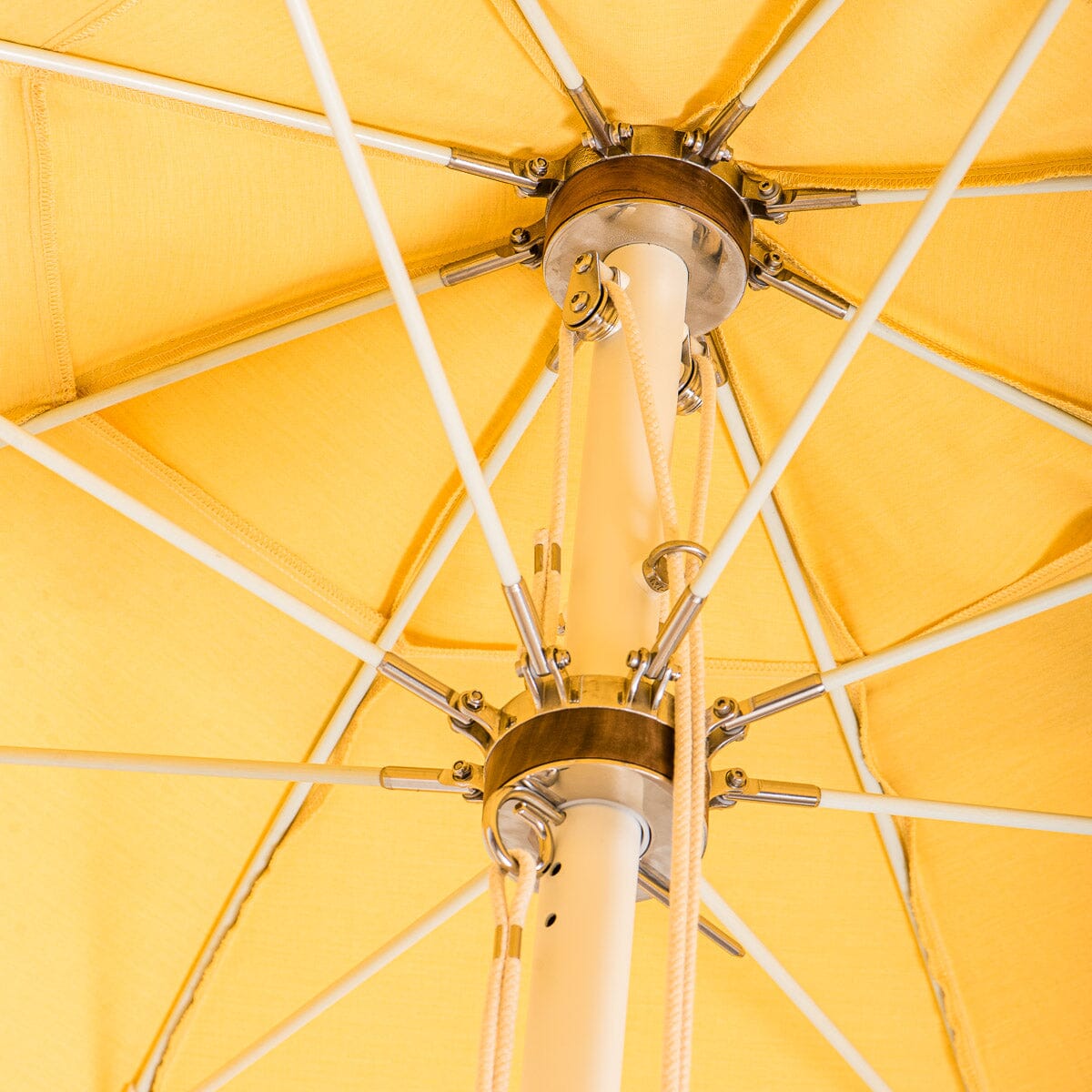 close up hardware detail on yellow patio umbrella