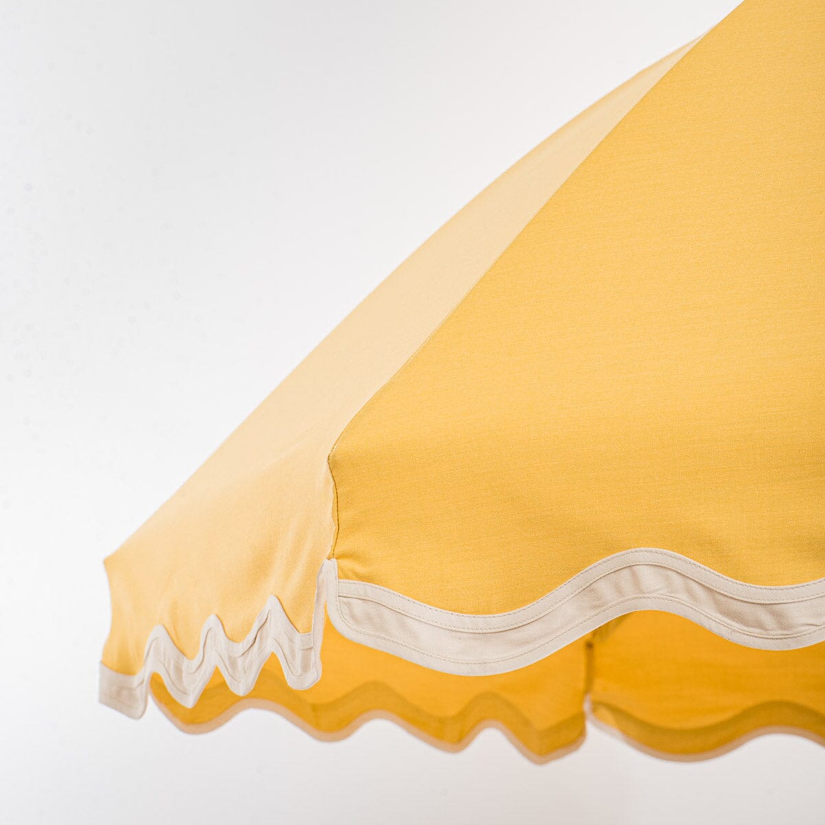 close up detail of canopy edge on yellow patio umbrella